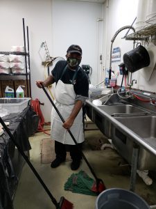 adult with disabilities employed at Eggleston cleaning the floor