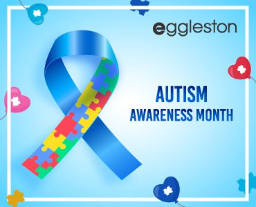 Awareness ribbon for Autism spectrum disorder (ASD) in blue and white with the text 'Autism Awareness Month' beside it.